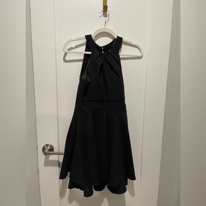 Cute little black dress, with straps and zippered back! Size M. 2 gold buttons